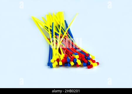 Multicolored cable clamps on a white background in the center of the screen Stock Photo