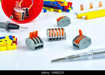 Electrical accessories, screwdriver, clamps, ties on a white background. Stock Photo