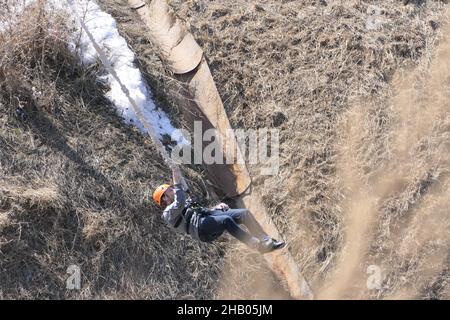 Nizhny Novgorod. Russia, Fedorovsky Embankment, 04.25.2021. A person tied to a rope jumps from a height. Bungee jump in the open air. High quality pho Stock Photo