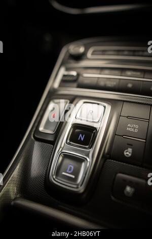 Close up shot of an automatic button gear shifter on a central console in a new car. Stock Photo