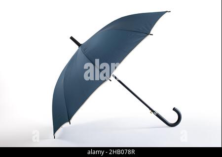 Opened blue umbrella isolated on white background. Studio shoot Stock Photo