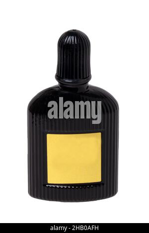 Cosmetic labels. Close-up of a black elegant male parfum glass bottle with empty yellow label isolated on a white background. Copy space. Adbvertising Stock Photo