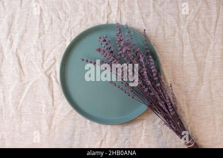 Green colored circle shaped ceramic plate on isolated background, food mockup Stock Photo