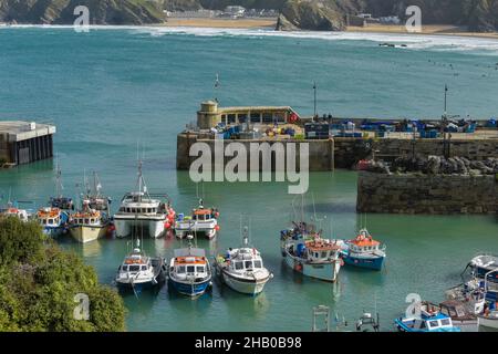 Fishing boats moored in the picturesque working harbour in Newquay in Cornwall. Stock Photo