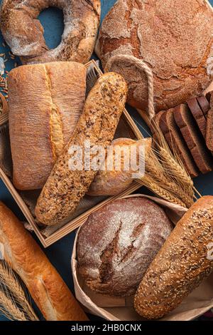 Fresh, crispy bread of various types and wheat close-up. Top view. Bread fund. Stock Photo