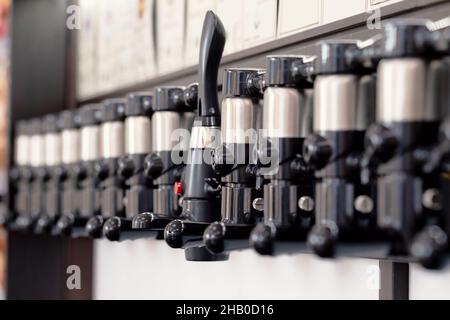 Beer taps for draught drinks are built into wooden boards in pub Stock Photo