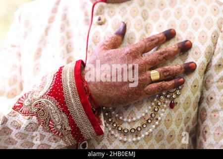 A closeup of an Indian groom wearing traditional dress sherwani Stock Photo