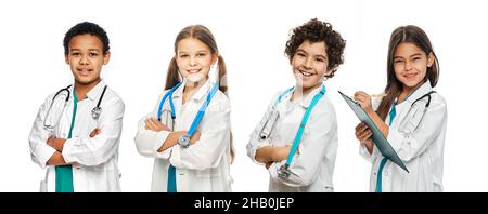 Group of positive multi-ethnic kids wearing medical uniforms and stethoscopes. medical healthcare and support, concept of future doctors occupation Stock Photo