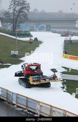 Dresden, Germany. 16th Dec, 2021. Two Pistenbullies prepare a future competition course with artificial snow on the banks of the Elbe. On 18 and 19 December 2021, Dresden will host the FIS Cross-Country Skiing Sprint World Cup. Credit: Sebastian Kahnert/dpa-Zentralbild/dpa/Alamy Live News Stock Photo