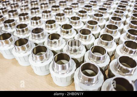 many metal pipe couplings in a pipe factory Stock Photo