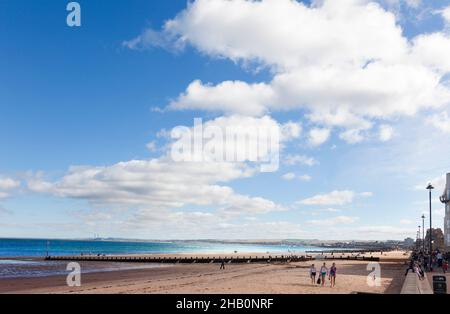 Edinburgh, Scotland-September 22, 2013: On sunny days, the people of Edinburgh take the opportunity to stroll along Portobello Beach Stock Photo