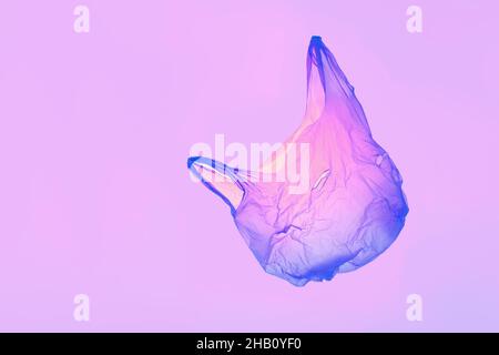 Transparent pink violet plastic bag in violet toned light Stock Photo