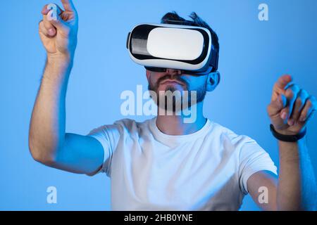 Young man designer or architector having virtual reality experience using vr headset. Stock Photo