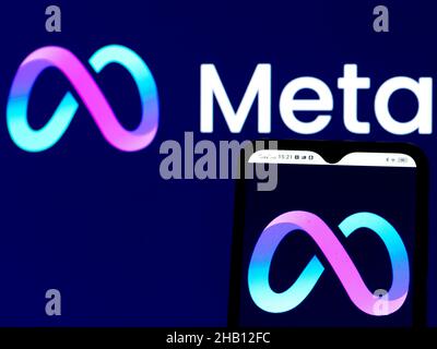 In this photo illustration Meta Platforms Inc. logo seen displayed on a smartphone and in the background. Stock Photo