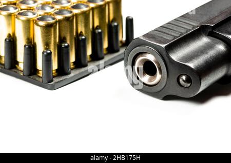 photo of a black pistol and bullets on a white background. Weapons Stock Photo