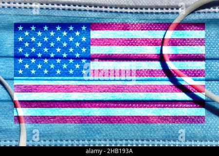 Grunge pattern of USA national flag isolated on blue media disposable face mask background Stock Photo