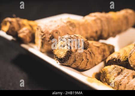 Ginger Roots on a dark background Stock Photo