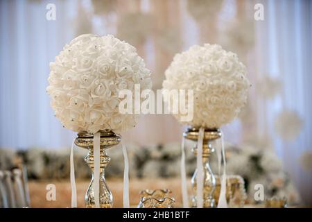 Gold table centerpieces with white ball flowers with diamonds Stock Photo