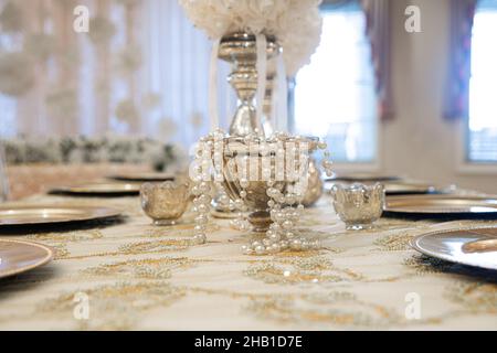 Gold table centerpieces with white ball flowers with diamonds Stock Photo