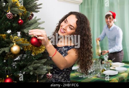 Couple decorating Christmas tree Stock Photo