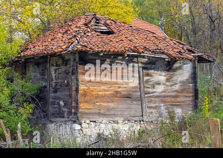 Caved in Roof Shingles at Abandoned Wooden House Stock Photo