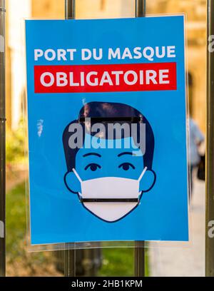 Sign in French states that wearing a mouth-nose covering is mandatory Stock Photo
