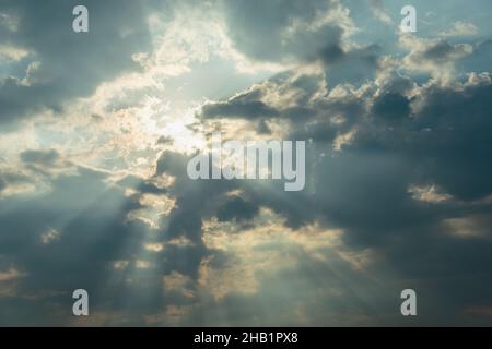 Glare of the sun and rays with clouds, sky background Stock Photo