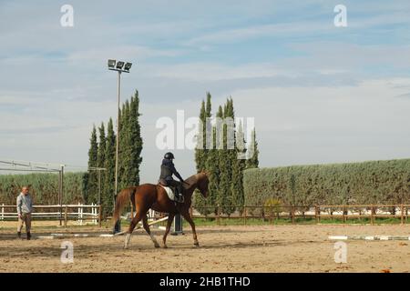 Kid leaning horseback riding at ranch. Stock Photo