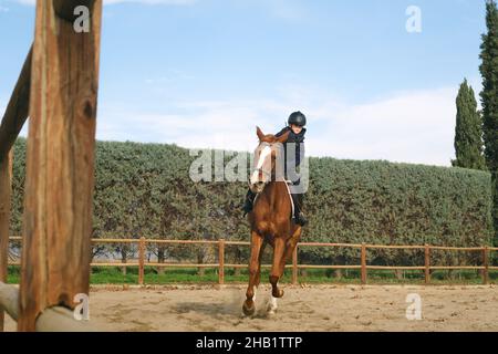 Boy galloping with horse at the ranch. Stock Photo