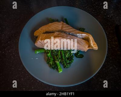Steamed salmon and broccoli on a blue plate Stock Photo