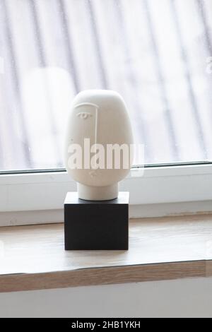 Plaster statue on wooden table Stock Photo
