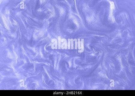 Violet paint background. Motion of the shiny liquid. Color of the year 2022 very peri. Waves on a glittering liquid surface. Stock Photo