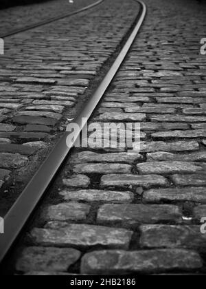 Vertical grayscale shot of a railroad Stock Photo