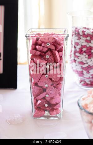 Heart shaped chocolate candies wrapped in pink aluminum foil at dessert bar Stock Photo