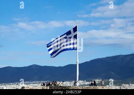 Athens, Greece - December 12, 2021: Greek flag flying over the Acropolis Stock Photo