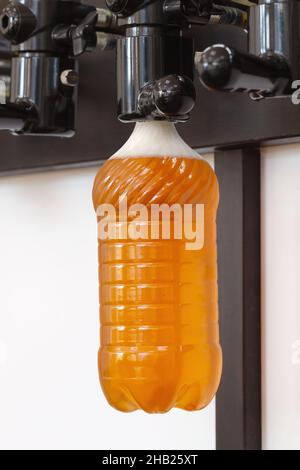 New modern beer taps with plastic bottles on bar counter in pub Stock Photo