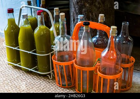 Traditional Oil Mill (Moulin a Huile Traditionnel) in Draguignan, France. Six-pack with fresh olive juice. The Moulin de Saint-Cassien has around 98 percent private customers. They bring their own bottles, have the olive oil bottled and have a chat with the press master Fabrice Godet. Stock Photo