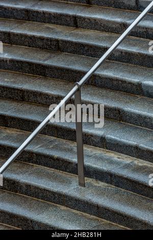 flight of concrete steps or stairs with metal handrail close up. concrete or stone stairway or flight of steps. Stock Photo