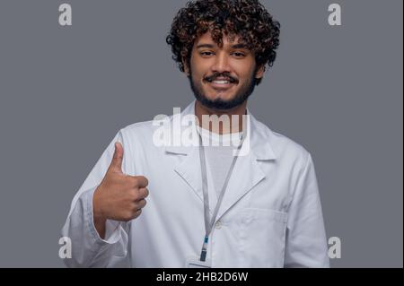 Joyful practitioner showing a sign of approval before the camera Stock Photo