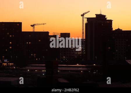 Sunrise in Leeds City Centre. The building silhouetted on the right is City Island apartments Stock Photo