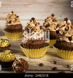 Ferrero Rocher Christmas chocolate cupcakes. Muffins with chocolate cream. Stock Photo