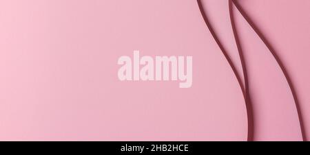 Abstract colored paper geometry composition monochrome background in pastel pink color with curved lines Stock Photo