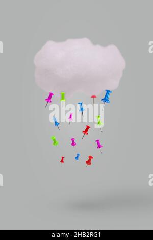 Creative idea made with cloud and push pins as rain isolated against gray background. Minimal weather concept. Stock Photo