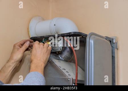 Repairing gas boiler water heater maintenance with service technician Stock Photo