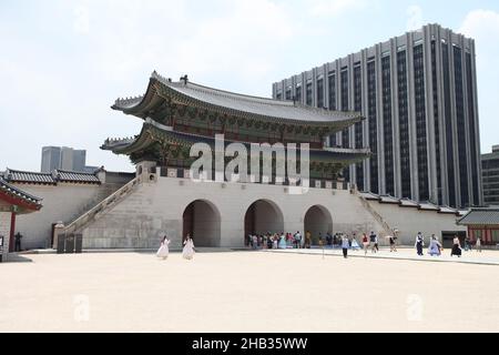 The Gwanghwamun Gate of Gyeongbokgung palace in Soul with old buildings in the background and many people near the gate. Stock Photo