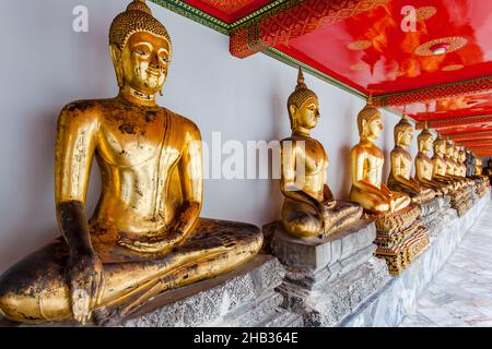 Gilt statues of the Buddha in buddhist temple in Bangkok, Thailand Stock Photo