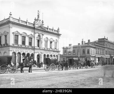 Dee Street, Invercargill, Burton Brothers studio, photography studio, 1880s, Invercargill, gelatin dry plate process, Street scene with horses and carts, people posed outside Athenaeum, (erected 1875 Stock Photo