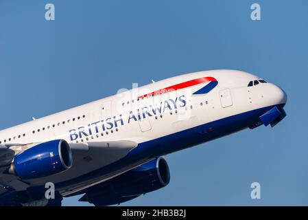 British Airways Airbus A380 superjumbo jet airliner plane G-XLEL taking off from London Heathrow Airport, UK, in blue sky Stock Photo