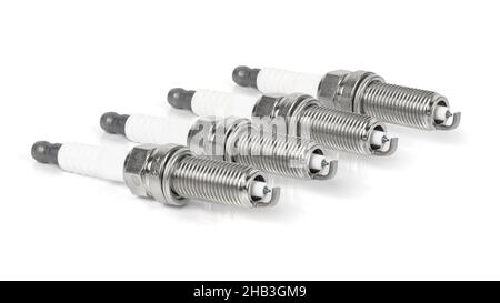 Four iridium spark plugs in a row isolated on white background with clipping path Stock Photo