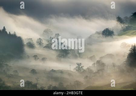 Kirkstone Pass, Cumbria, UK. 16th Dec, 2021. Weather. Atmospheric scenes from the fanmous Kirkstone Pass looking over Windermere, as a cloud inversion creeps up the valley. Credit: Wayne HUTCHINSON/Alamy Live News Stock Photo